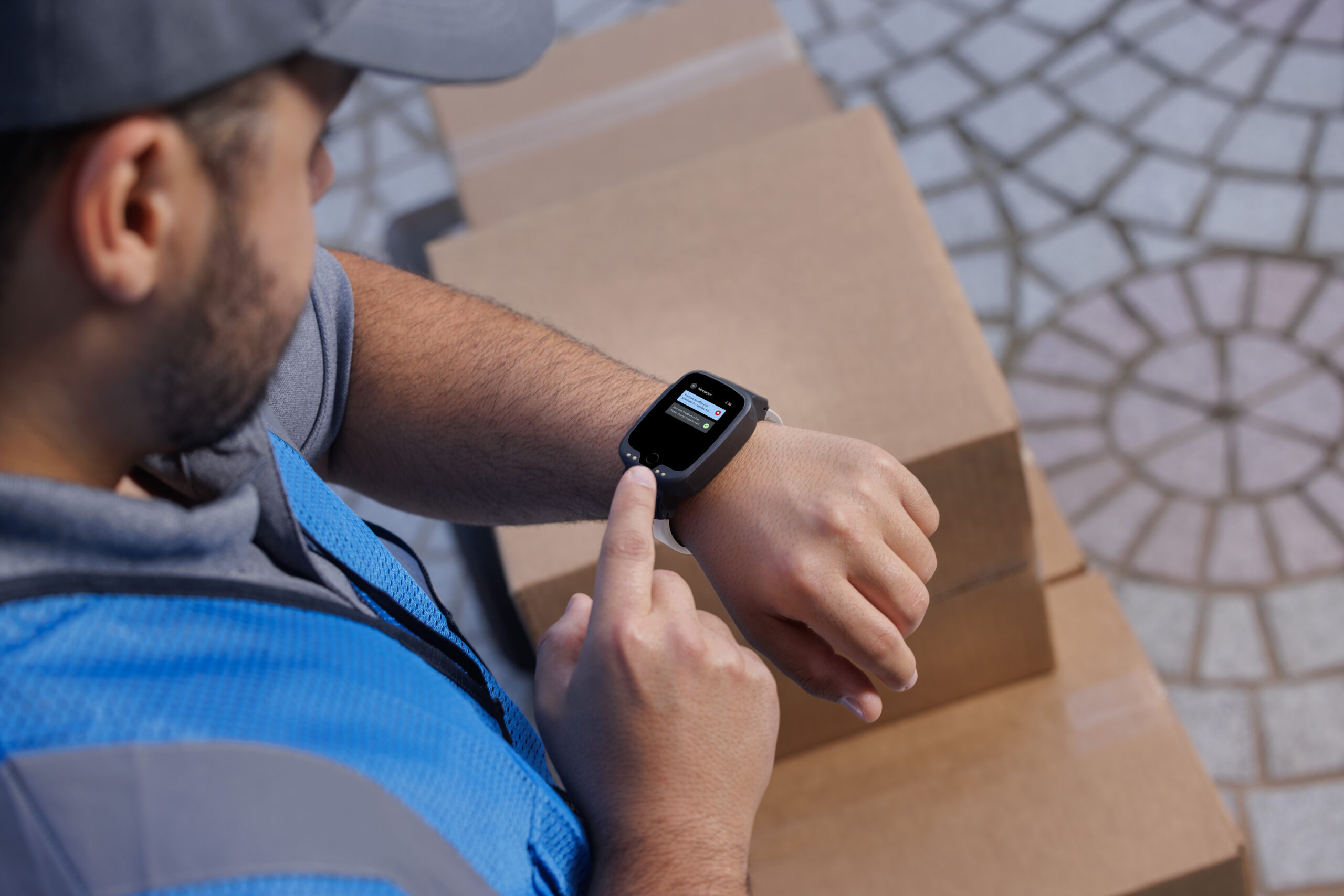Man with GPS wrist-worn device uses simple communication feature to check messages from officer.